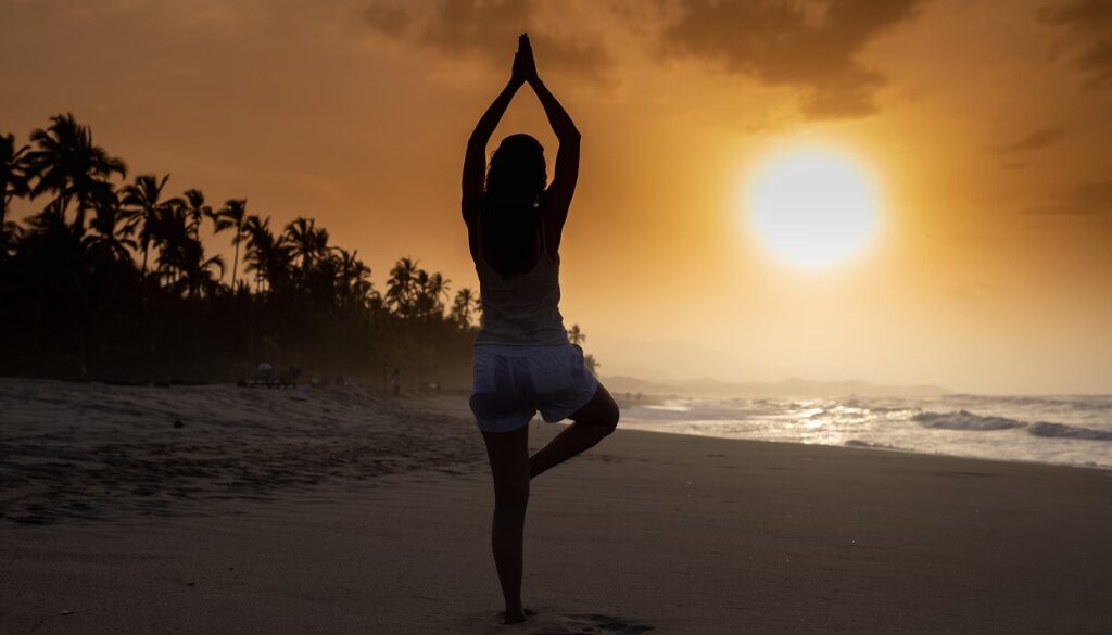 Person meditating at sunrise, symbolizing a positive mindset